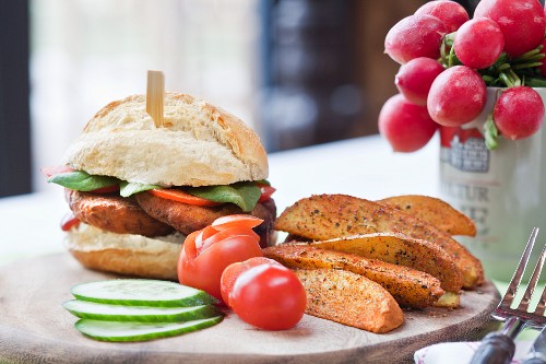 A veggie burger with spicy potato wedges