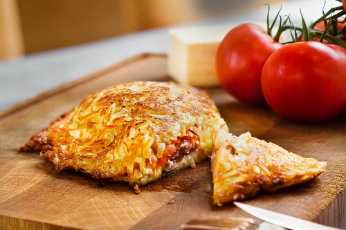 A potato rosti filled with minced beef, cheese and tomatoes
