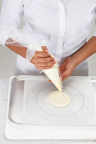 Prepare macaron cake Pipe on meringue mixture in a circle