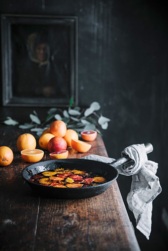 Caramelized blood oranges in an iron pan