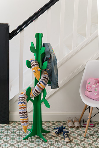 A crocheted snake on a coat stand