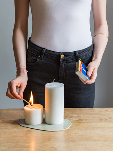 A homemade pillar candle being lit