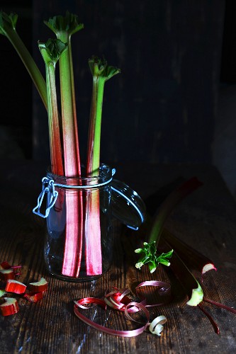An arrangement of fresh rhubarb spears in a flip-top jar
