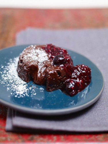 Upside-down chocolate cake with berry sauce