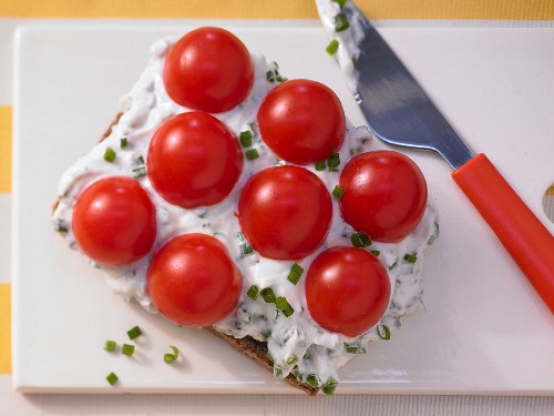 Seeded wholemeal bread topped with herb quark and cherry tomatoes