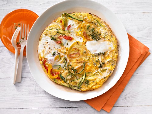 A potato tortilla with peppers and courgette