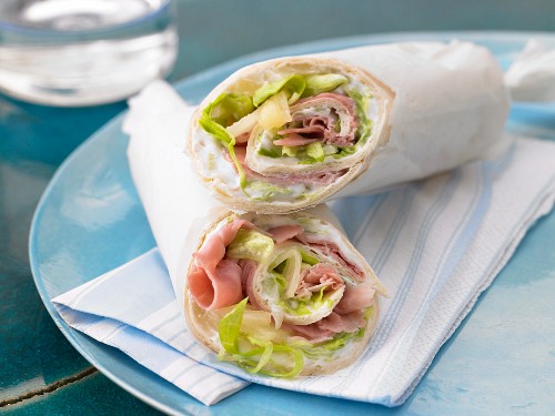 A wrap with ham, cream cheese, pineapple and lettuce