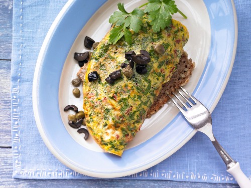 A tomato and herb omelette on pumpkin seed bread