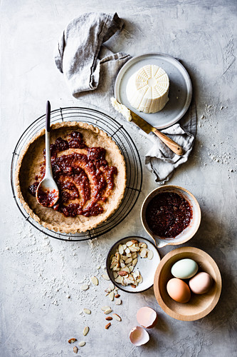 Cooking of an Italian Jam and Ricotta Tart on a gray background