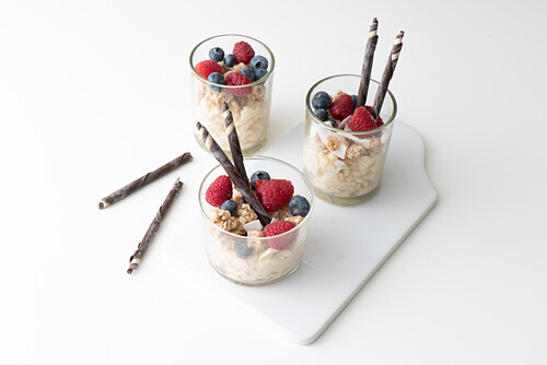 Almond milk rice pudding with muesli flakes and berries
