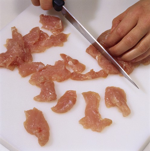 Cutting turkey meat into strips
