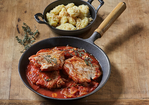 Pork chops with tomatoes and roasted gnocchi