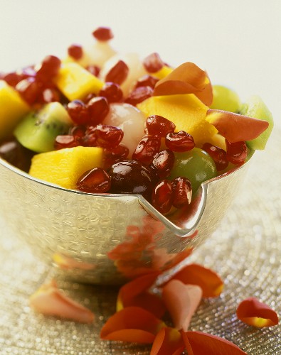 Fruit salad with exotic fruit and rose petals
