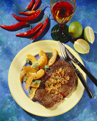 Caribbean beef steak with onions and apricot salad
