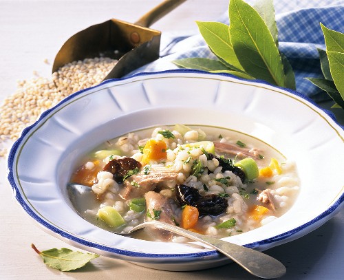 Pearl barley soup with prunes, vegetables and duck 