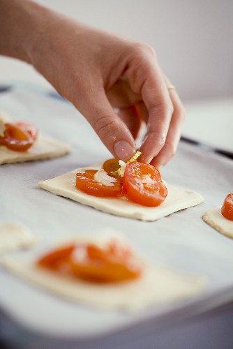 Putting tomatoes on puff pastry