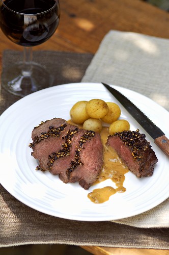 Venison steaks with pepper crust & boiled potatoes