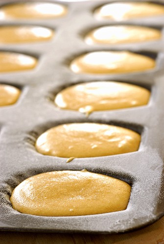 Unbaked lemon madeleines in the baking tin