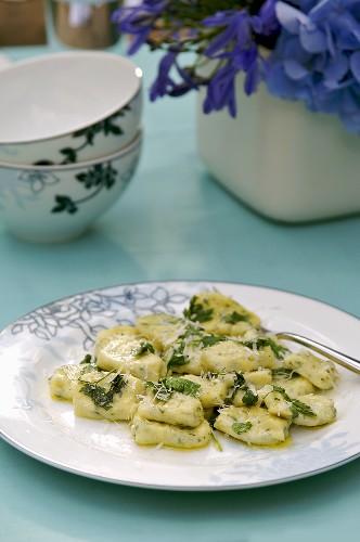 Herb gnocchi with sage butter on a plate