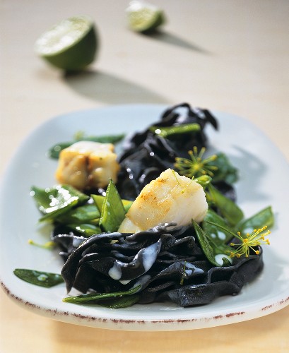 Squid ink pappardelle with fried zander and mangetout