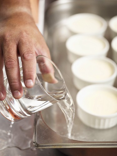 Vanilla cream in moulds in a bain marie