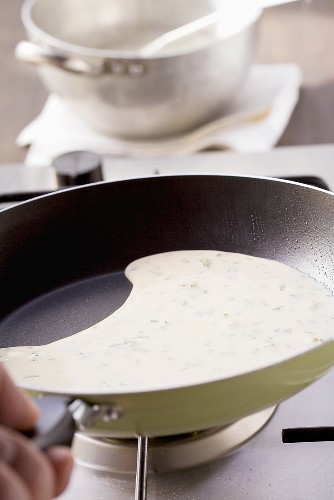 A herb pancake being fried