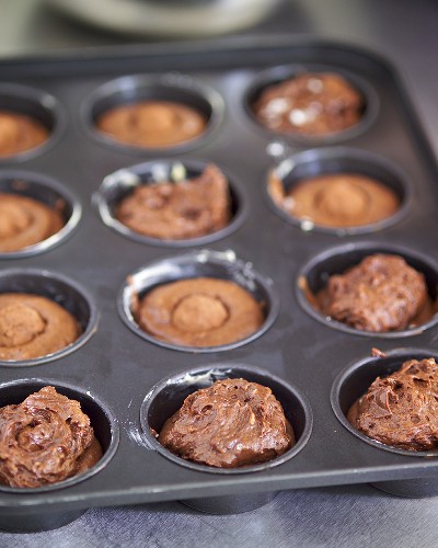 Chocolate muffin mixture in muffin tin