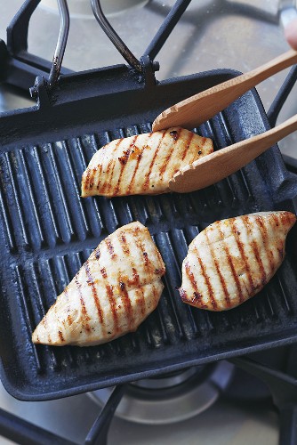 Grilling chicken breast on a grill pan