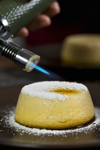 Goat's cheese flan being flambéed