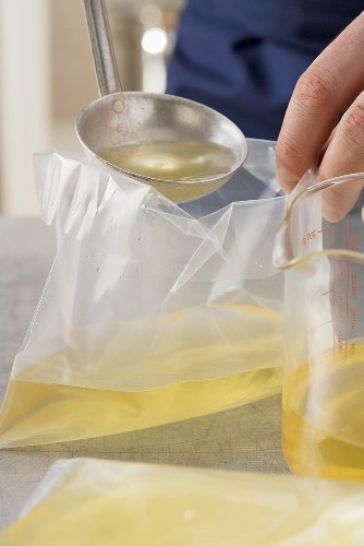 Fish stock being poured into freezer bags