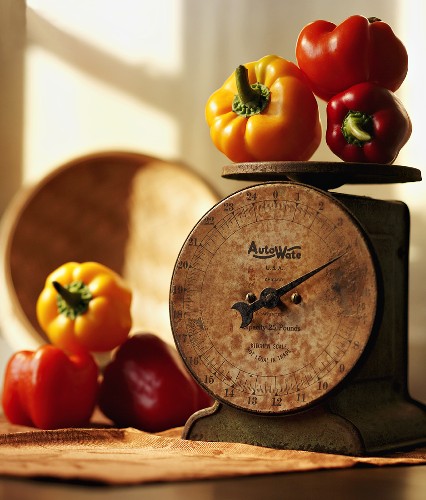Red, Yellow and Orange Bell Peppers on a Scale