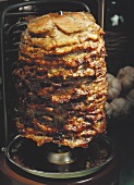 Many Slices of Roasted Lamb on a Metal Skewer