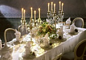 Festively Set Table with Candleabras and Violets