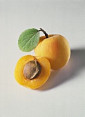 Two Fresh Apricots; One Whole and One Half