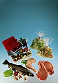 Frozen food still life with fish, meat, vegetables and fruit
