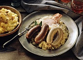 Blood and liver sausages with smoked pork on sauerkraut