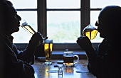 Two men drinking Pils in pub