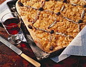 Tray-baked onion cake with olives & anchovies