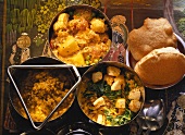Spinach with diced cheese; potato curry; dal & puri