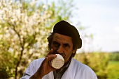 A French Man Sniffing a Cheese Wheel