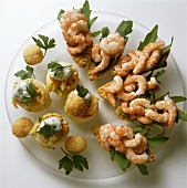 Shrimp boats and vegetable vol-au-vents on sheet of glass