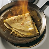 Crepes suzette with orange butter, flambéed in frying pan