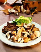 Mixed mushrooms, lettuce and pork cutlet on plate