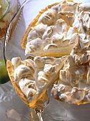 Lime pie with meringue on round glass plate
