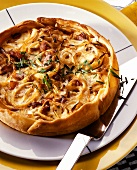 Round onion and bacon quiche in short pastry case