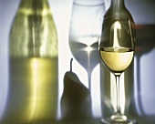 Glass of White Wine with Reflected Bottle