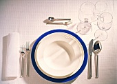 Table setting with white plates and blue plate