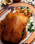 Roast Christmas duck with apple & raisin stuffing on plate
