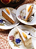 Three pieces of Swiss carrot cake on plates