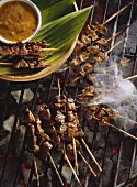 Beef Satay Cooking on a Grill; Smoke
